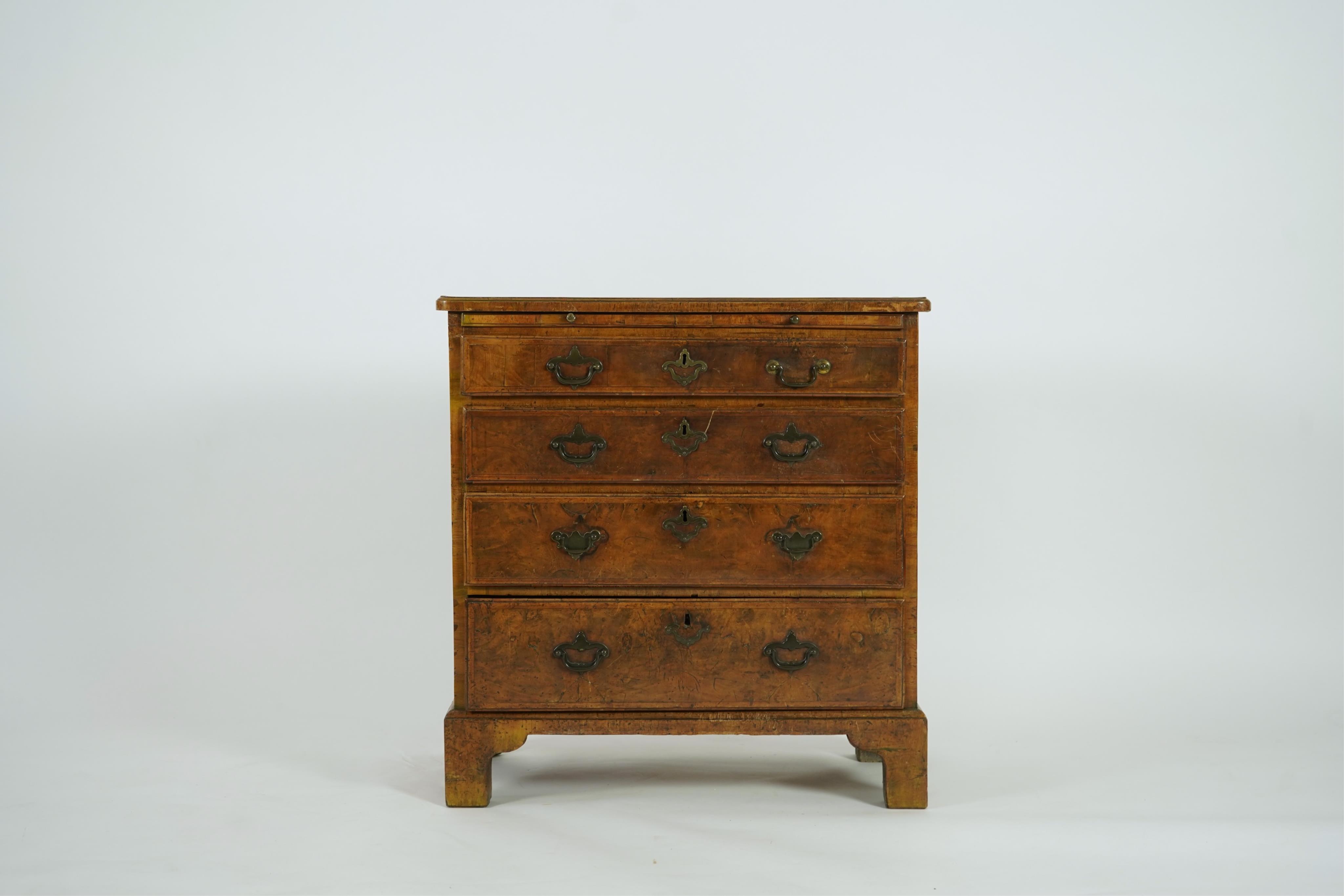 A small early 18th century and later cross and feather banded walnut veneered chest